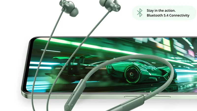 Realme Buds Wireless 3 Neo in Forest Green color, displayed in front of a smartphone screen showing a racing game, highlighting Bluetooth 5.4 connectivity