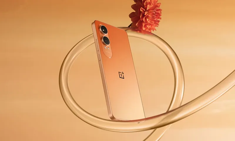 OnePlus Nord CE4 Lite smartphone in orange color displayed against a matching background with a flower, showcasing its sleek design and dual camera system.